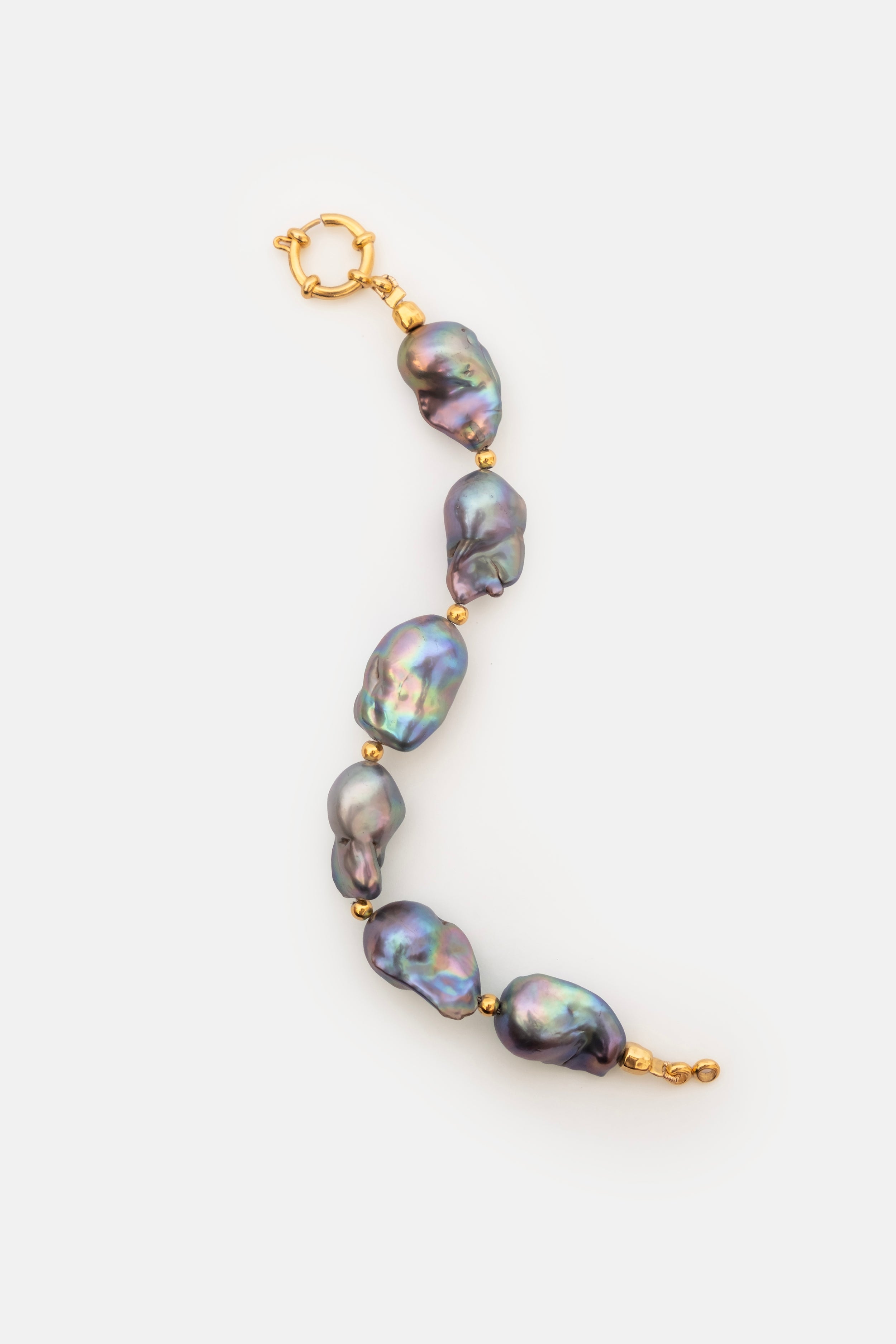 Pearl bracelet with gold clasp on a white background