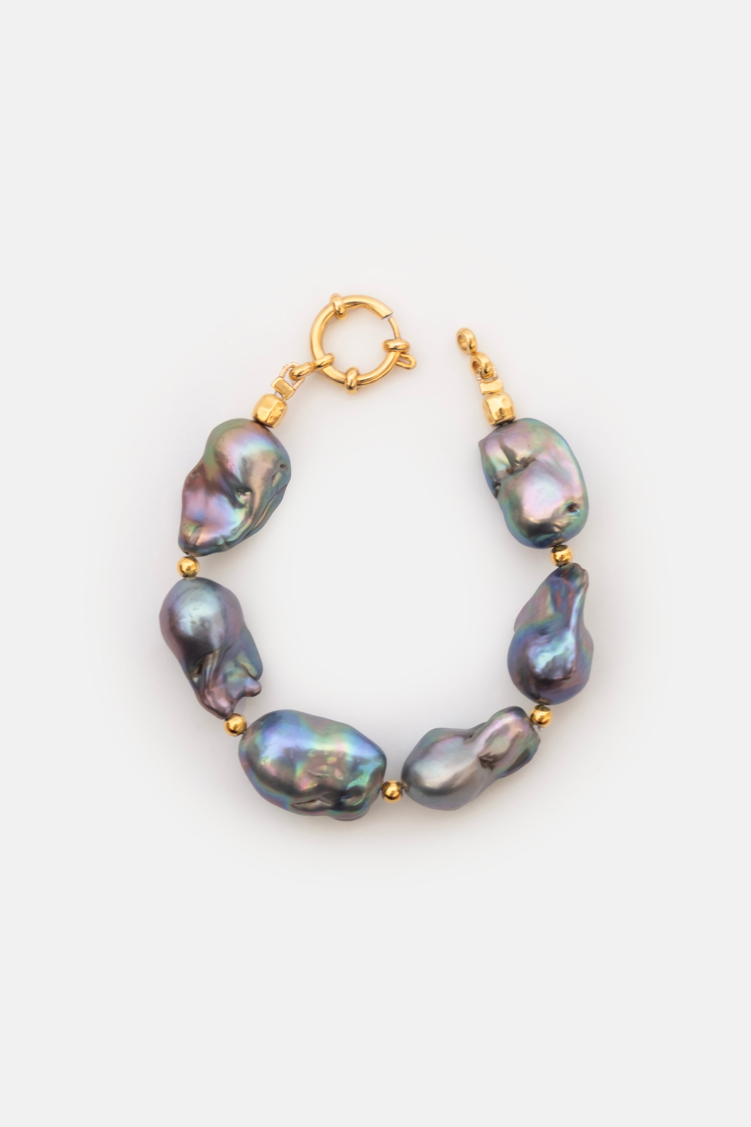 Pearl bracelet with gold clasps on a white background