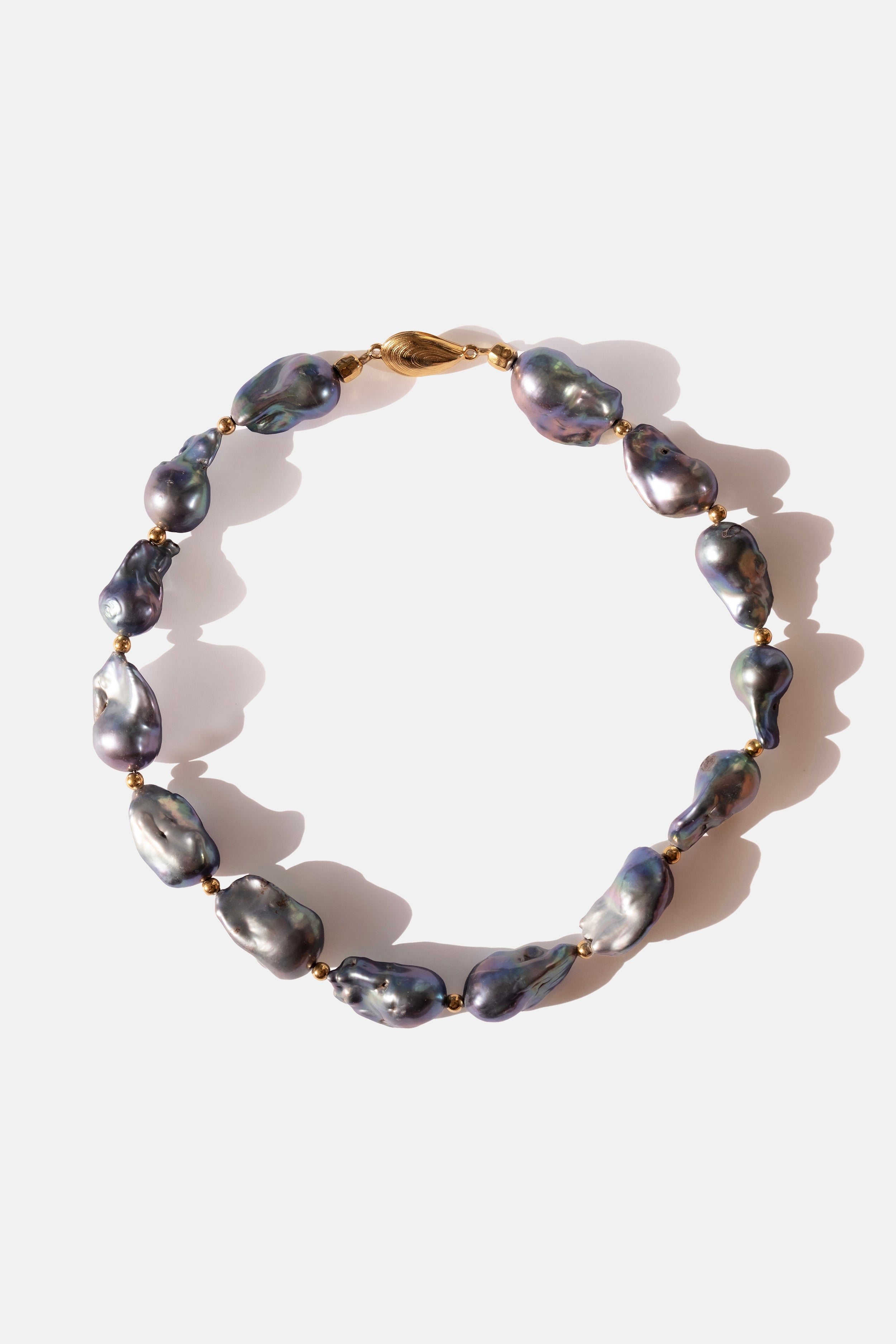 Pearl choker necklace with gold clasp on a white background