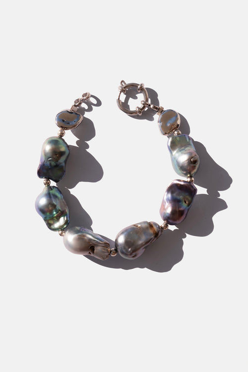 Pearl bracelet with silver clasps on a white background