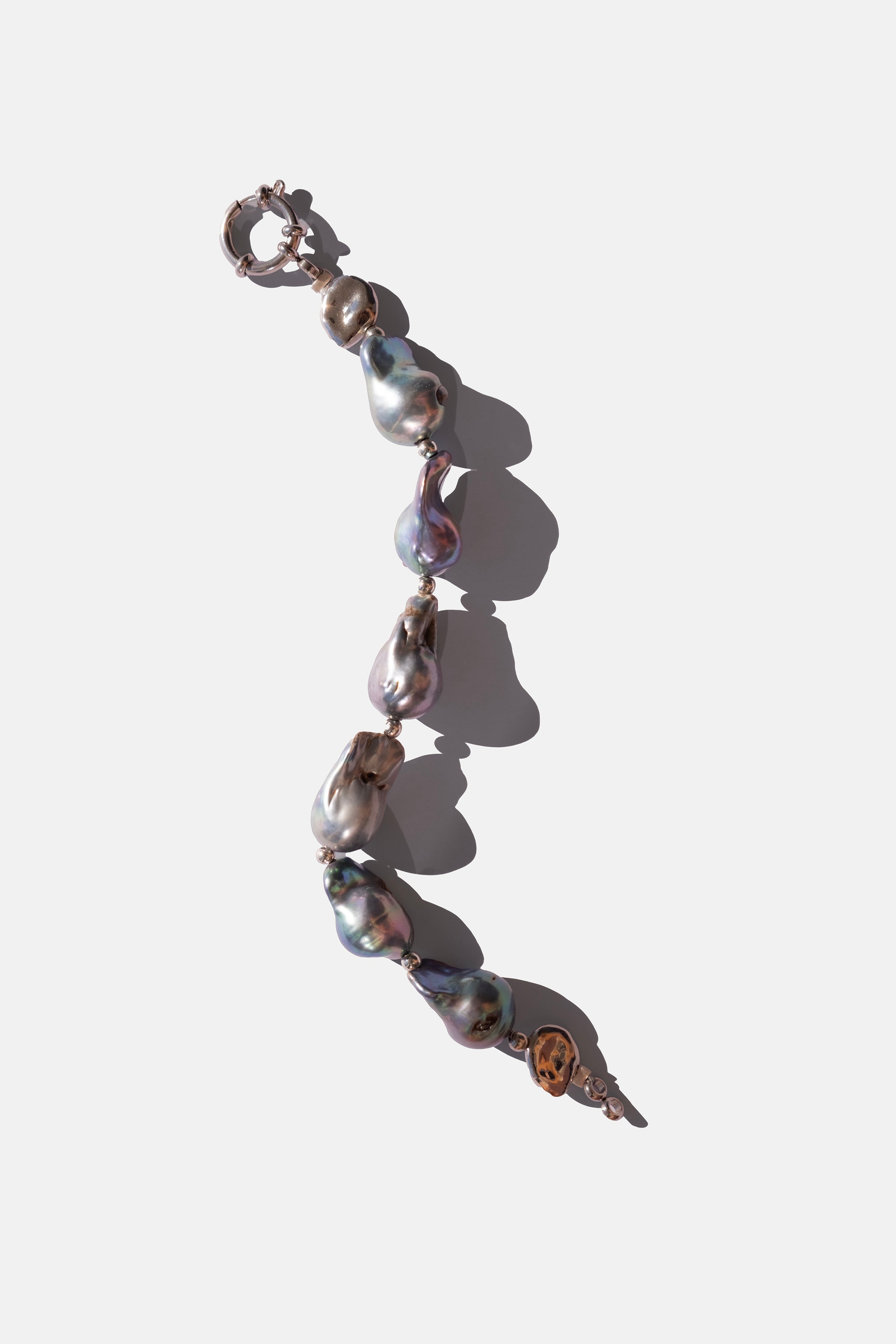 Pearl bracelet with silver clasp on a white background