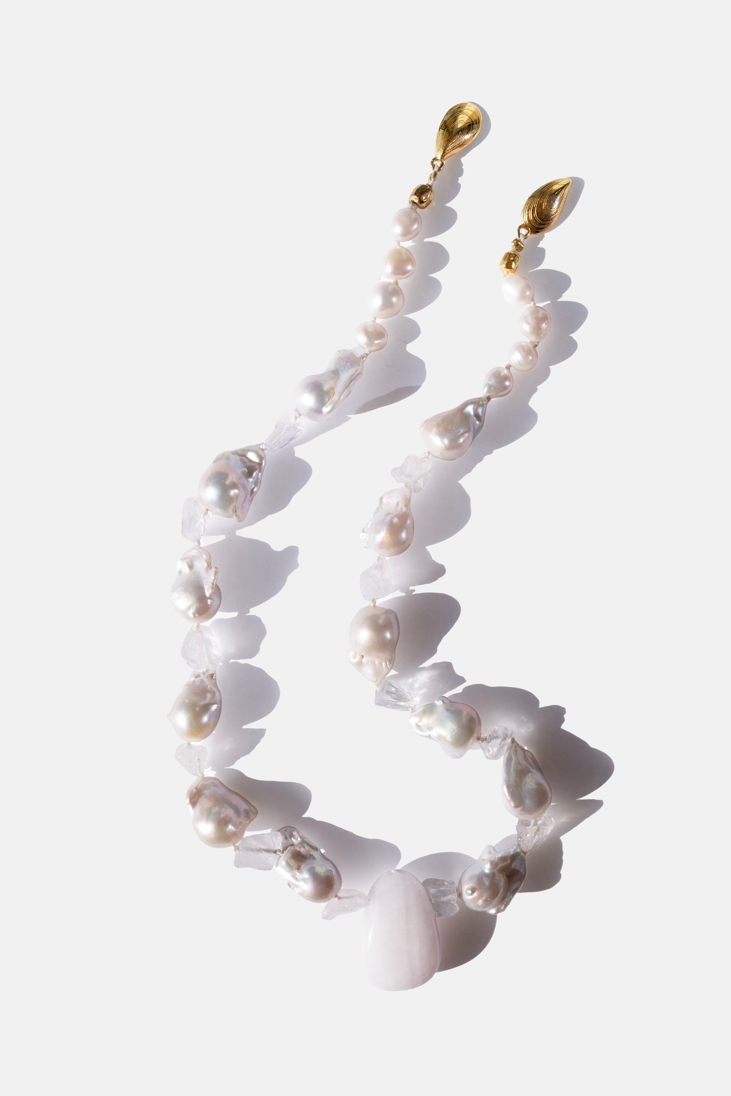 Necklace with white quartz beads and pearl elements on a white background
