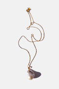 Gold chain necklace with a pearl on a white background