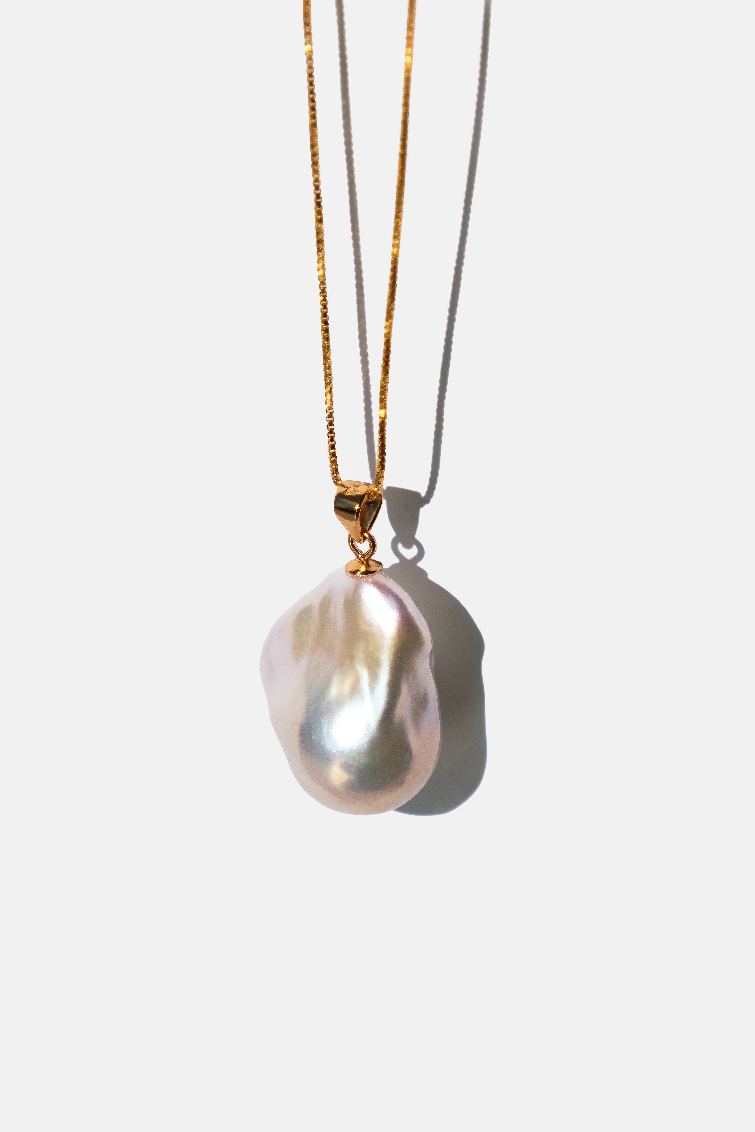 Pearl chain necklace with gold chain on a white background