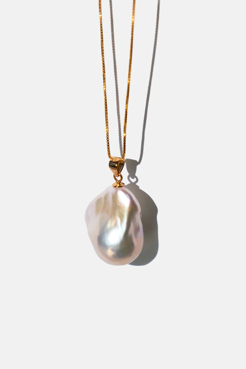 Pearl chain necklace with gold chain on a white background