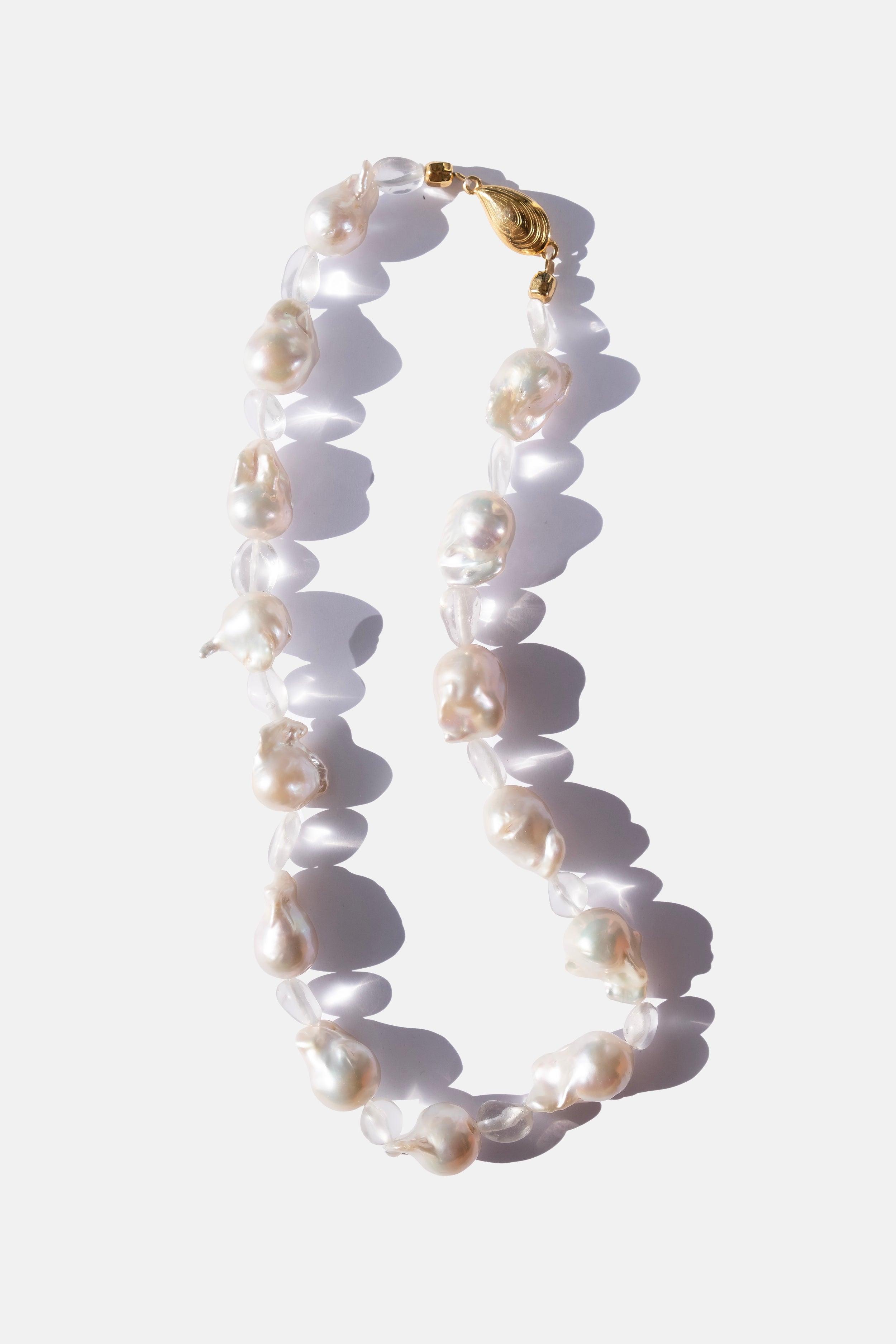 Pearl necklace with a gold clasp on a white background